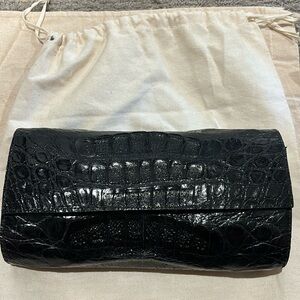 Real black crocodile clutch with 25 inch attachable shoulder strap.
